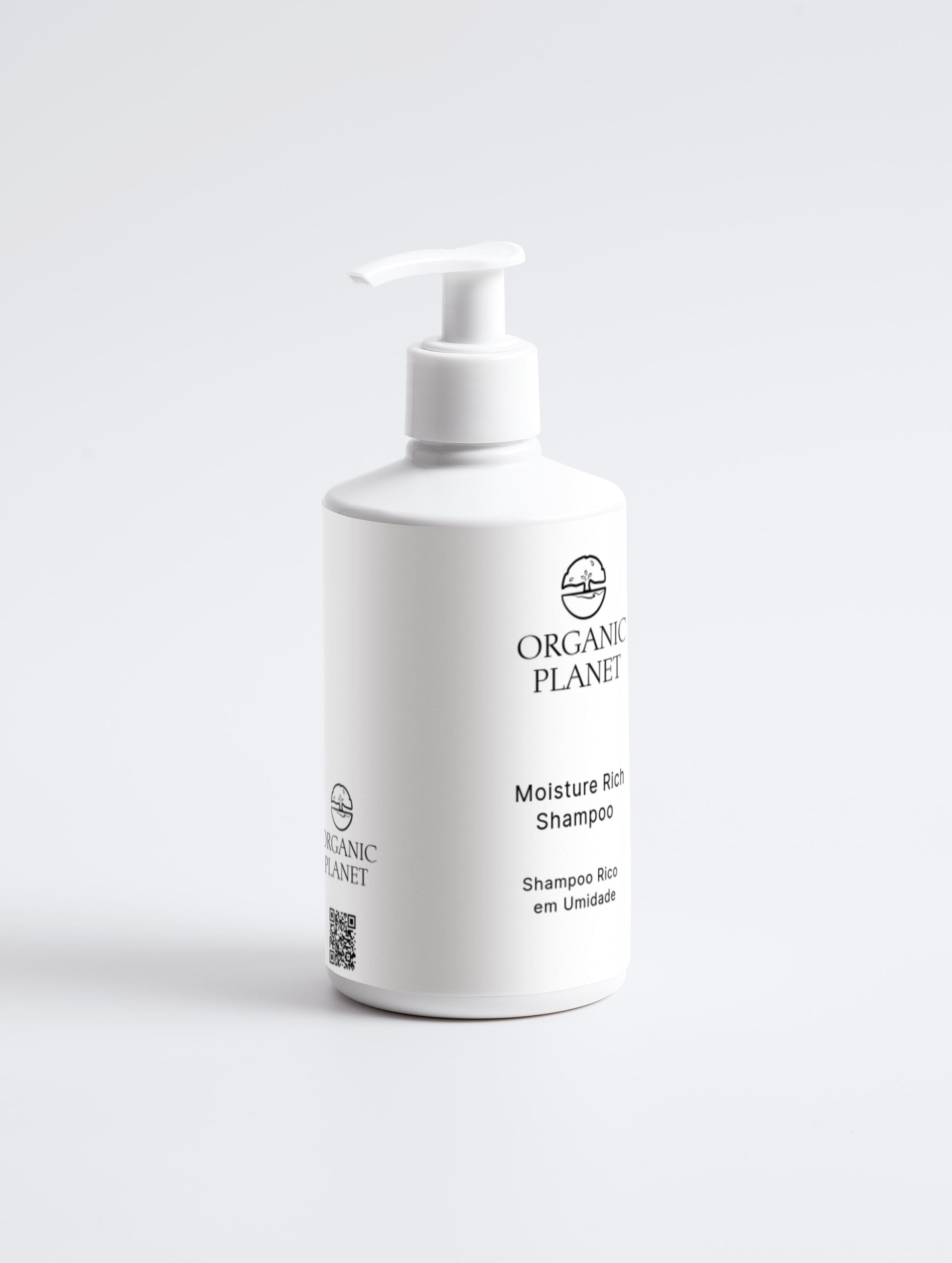 White shampoo bottle with pump labeled 'Organic Planet' on a light gray background