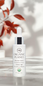 Organic Planet Maple Elastin Boost Serum bottle on a neutral with red maple leaves in background